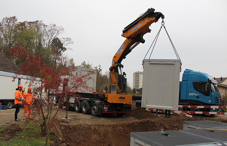 <em>Massarbeit:</em> Der fünfte der sechs Behälter der Unterflursammelstelle wird versetzt. Foto: AG