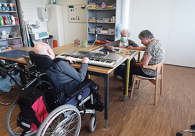 Keyboard spielen und Puzzle legen: Jeder darf tun, was geht und Freude macht – mit Begleitung von Marianne Brudermann (hinten). Foto: zvg
