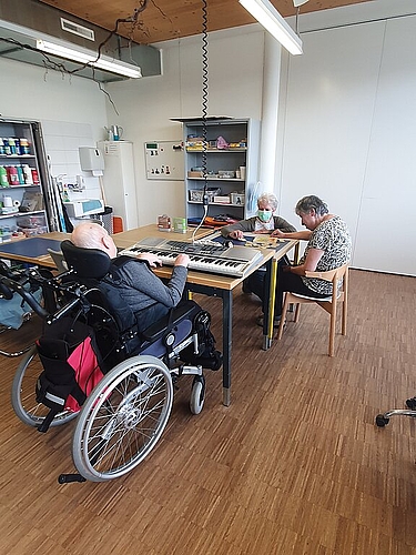 Keyboard spielen und Puzzle legen: Jeder darf tun, was geht und Freude macht – mit Begleitung von Marianne Brudermann (hinten). Foto: zvg
