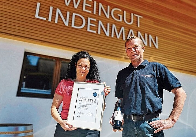 Stolz auf die Auszeichnung: Christina und Thomas Lindenmann mit Gewinnerurkunde und einer Flasche Aargauer Staatswein. Foto: Fritz Thut
