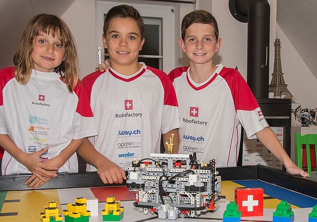 Noch todmüde, aber schon wieder am Roboter: Nina (7 Jahre), Elias (12) und Jesse (11) sind stolz auf das Erlebnis «World Robot Olympiad» in Costa Rica. Foto: Peter Winkelmann