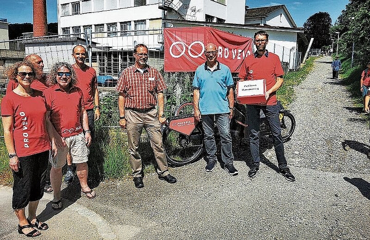 Petitionsaushändigung am Dammweg: Begleitet von Mitgliedern übergibt Pro-Velo-Lenzburg-Präsident Michael Oberle (rechts) Stadtrat Martin Stücheli und Christian Brenner (Abteilungsleiter Tiefbau und Verkehr) die 315 Unterschriften. Foto: Fritz Thu