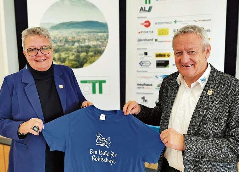 Bereit fürs Dorfjubiläum: Gemeindeammann Mirjam Tinner und OK-Präsident Ruedi Hediger präsentieren ein Helfer-T-Shirt. Foto: Fritz Thut