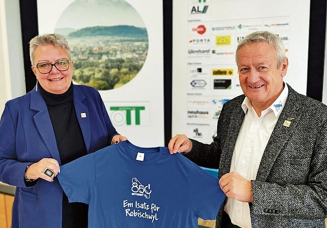 Bereit fürs Dorfjubiläum: Gemeindeammann Mirjam Tinner und OK-Präsident Ruedi Hediger präsentieren ein Helfer-T-Shirt. Foto: Fritz Thut