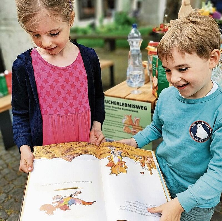 Angebot für Familien: Kinder mit Drachenbuch beim Start zum ErlebnisWeg. Foto: Fritz Thut