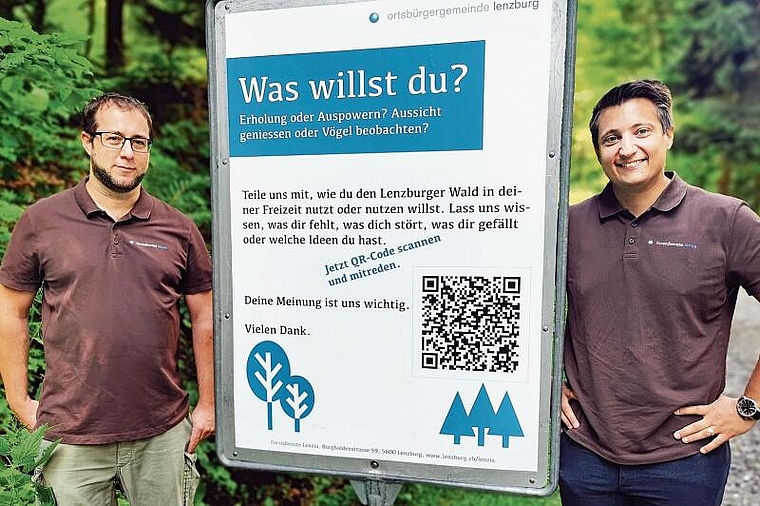 Suchen Meinungen der Waldnutzer: Stadtoberförster Matthias Ott und Vizeammann Andreas Schmid neben einem Plakat. Foto: Fritz Thut