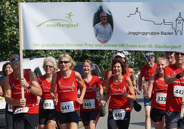 <em>Ein Bier auf das Jubiläum:</em> Die Jogginggruppe Baden gratulierte ihrem Mitglied Christian Frey zum Jubiläum. Die Dame ganz links lief tatsächlich mit einer Bierdose in der Hand ins Ziel. Foto: Ruedi Burkart