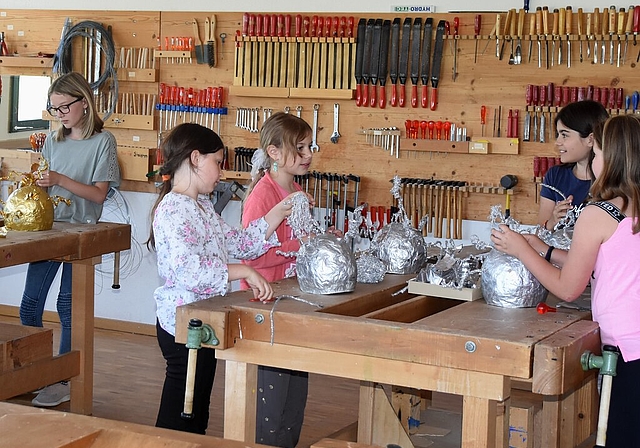 <em>Basteln im Werkraum: </em>Im Werkraum der Schule fertigen die Kinder der vierten Klasse ihre Helme, die sie beim Umzug tragen werden. Foto: Andreas Walker
