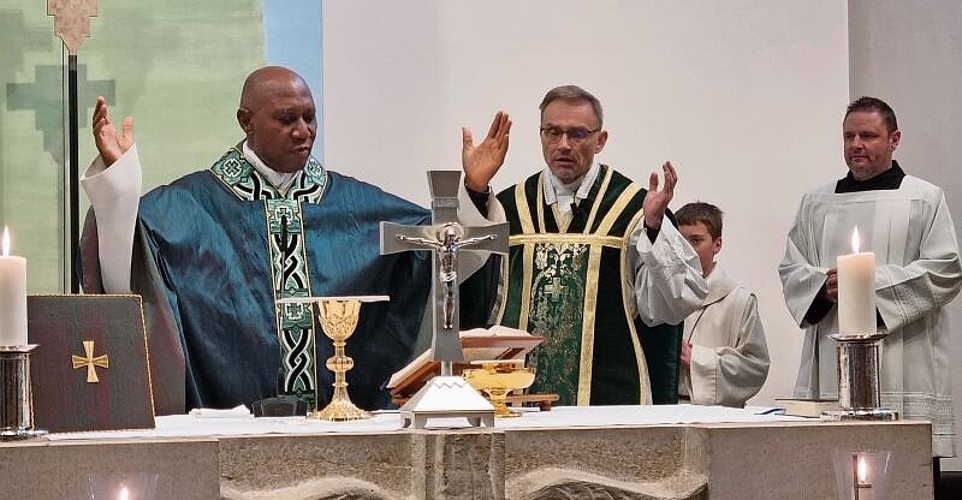 Obiora Ike und Stadtpfarrer Roland Häfliger beim Gebet am Altar, rechts von ihnen Sakristan André Huber.Foto: Stefan Treier